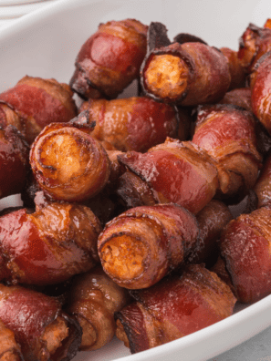 Exploring variations of Air Fryer Bacon Wrapped Tater Tots can add exciting new flavors and textures to this appetizing snack. Here are some creative ideas to try: Cheese Stuffed: Before wrapping the tater tots in bacon, press a small cube of cheese (like cheddar or mozzarella) into the center of each tot for a gooey, cheesy surprise. BBQ Glaze: Brush the bacon-wrapped tots with your favorite BBQ sauce before air frying for a tangy and smoky flavor profile. Spicy Sriracha: Mix Sriracha sauce with a bit of honey and brush it onto the bacon before wrapping around the tots for a spicy kick. Ranch Seasoning: Sprinkle ranch seasoning over the bacon-wrapped tots before cooking to add a herby and tangy flavor. Parmesan Crusted: After wrapping the tots in bacon, roll them in grated Parmesan cheese for a crispy, cheesy exterior. Sweet and Savory: Combine maple syrup with a pinch of ground cinnamon and brush it over the bacon-wrapped tots for a sweet and savory twist. Garlic Butter: Mix melted butter with minced garlic and brush it over the tots before and after air frying for a rich, garlicky flavor. Everything Bagel Seasoning: Sprinkle everything bagel seasoning over the bacon-wrapped tots for a crunchy, oniony, and savory addition. Jalapeño Popper Style: Place a slice of jalapeño on top of each tater tot before wrapping in bacon for a spicy popper-style twist. Honey Mustard Dip: Serve the cooked tots with a honey mustard dipping sauce for a delightful sweet and tangy flavor combination. Each of these variations brings a unique twist to the classic Air Fryer Bacon Wrapped Tater Tots, allowing you to cater to different tastes and occasions. Feel free to experiment and create your own versions based on the flavors you love!