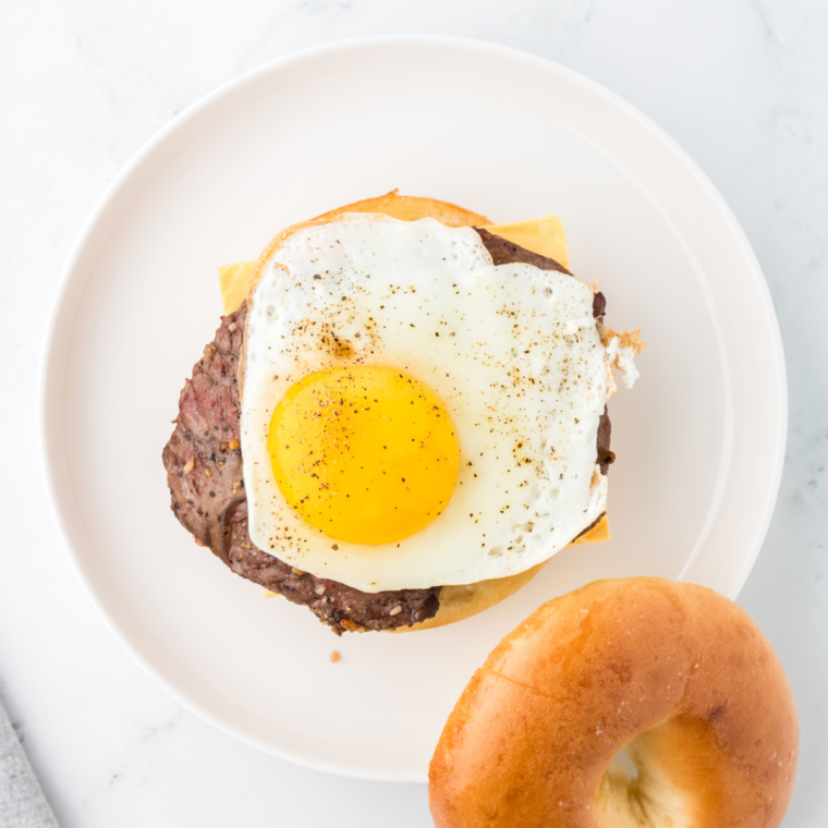 Assembling the steak, egg, and cheese layers for your Copycat McDonald’s bagel.