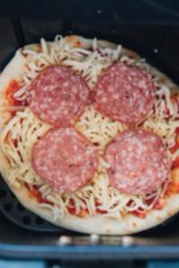 Cook for 4 minutes
Loaded pepperoni naan pizza cooking in the air fryer at 380&deg;F with melted bubbling mozzarella, golden-brown crispy edges, and pepperoni curling at the edges
