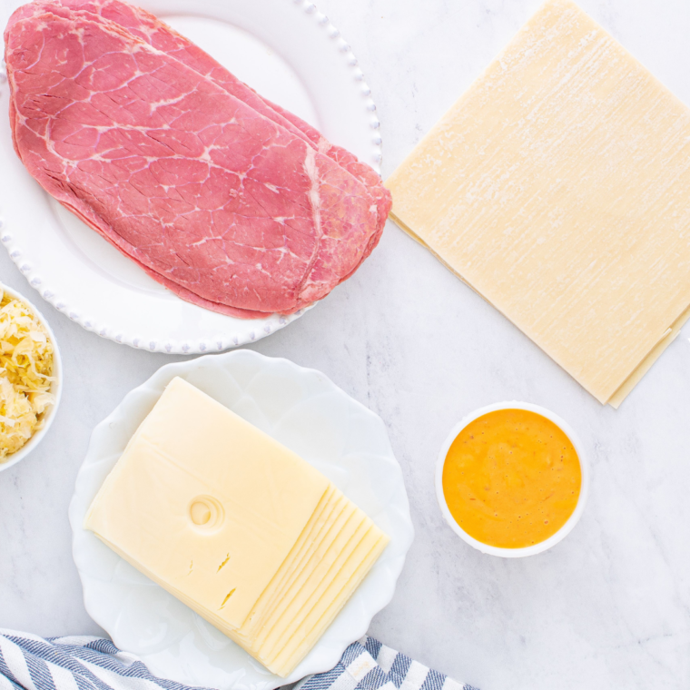 Ingredients needed for Air Fryer Reuben Egg Rolls on kitchen table.