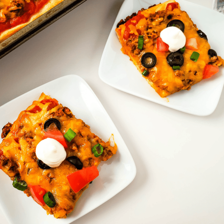 "Close-up of Air Fryer Taco Pizza featuring taco seasoning, cheese, and fresh toppings."