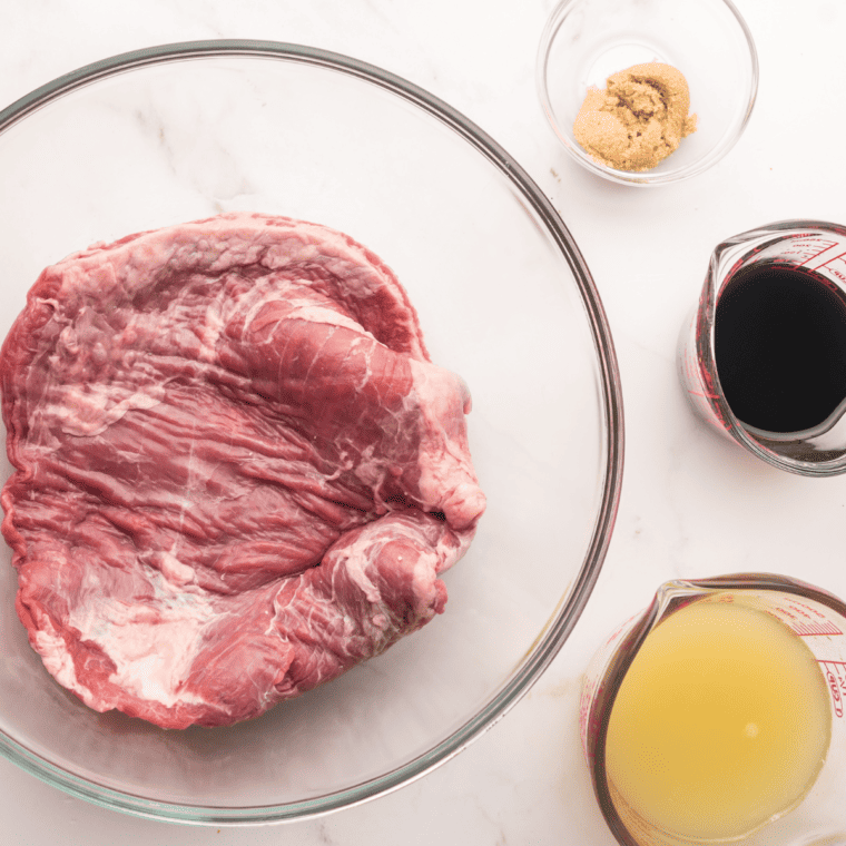 Marinating flank steak in a large bowl with lime juice and soy sauce for 2-4 hours.