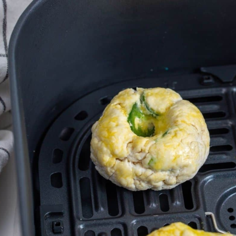 a dairy-free bagels in air fryer basket, ready to be enjoyed with various toppings