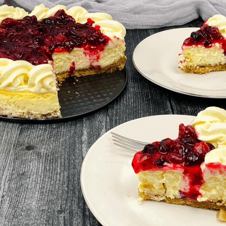 Slice of Cheesecake Factory-style cranberry cheesecake with a smooth cream cheese filling and bright cranberry swirl on a graham cracker crust.