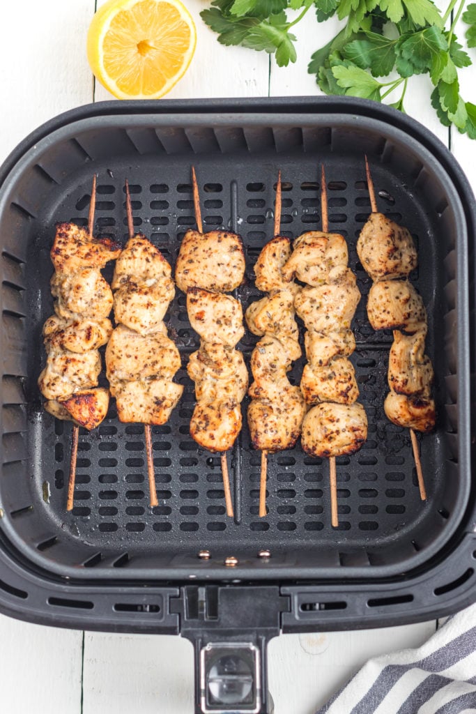 marinate chicken pieces on skewers in air fryer basket