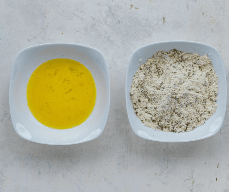 bowl of egg mixture next to bowl of seasoned flour