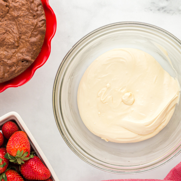 Cream cheese frosting beaten smooth in a mixing bowl