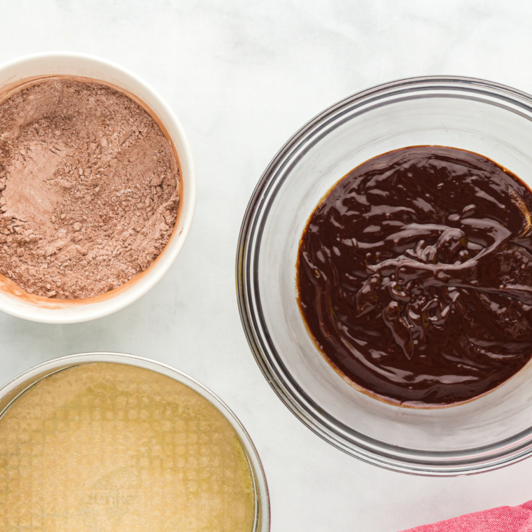 Melted butter and chocolate chips stirred smooth in a small bowl