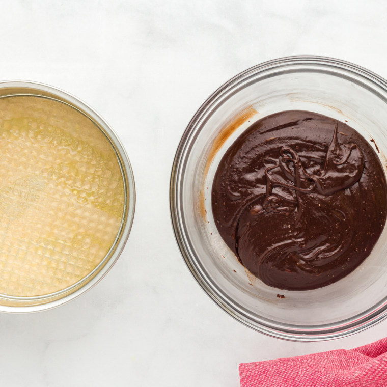 Fudgy brownie batter whisked smooth in a mixing bowl