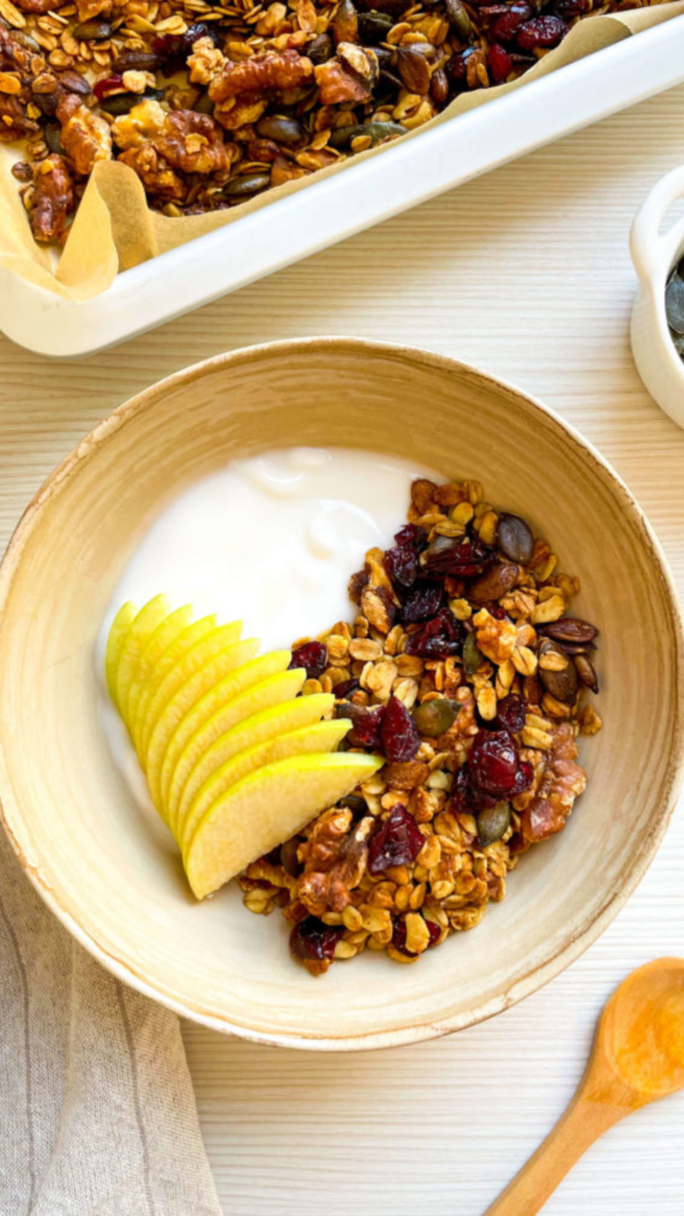 Air Fryer Cranberry Granola in a large wooden bowl, being served