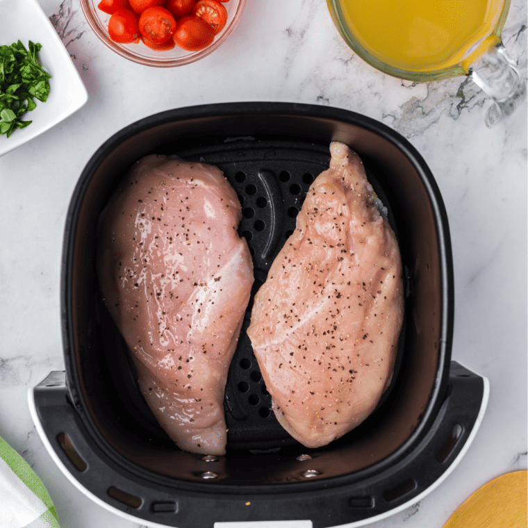 Place the seasoned chicken in the air fryer basket.