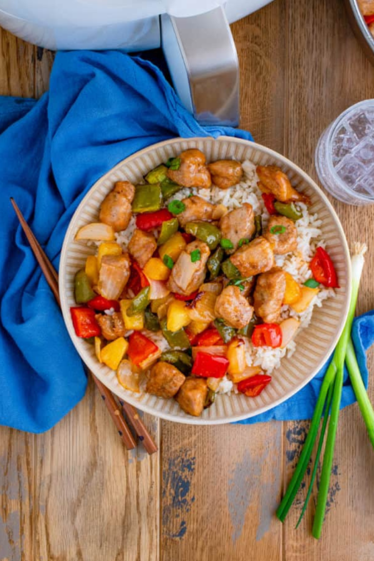 Air Fryer Pork Stir Fry with pork tenderloin, bell peppers, broccoli, and carrots served in a bowl with a savory sauce.