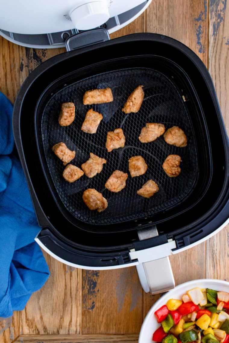 After marinating, toss pork with oil and cornstarch, then cook in the air fryer for crispy, tender pork with an internal temperature of 145°F.