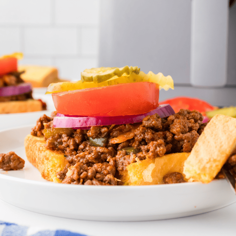 Open-Faced Sloppy Joes - Wahlburger Copycat served on a plate with melty cheese and toasted bread.