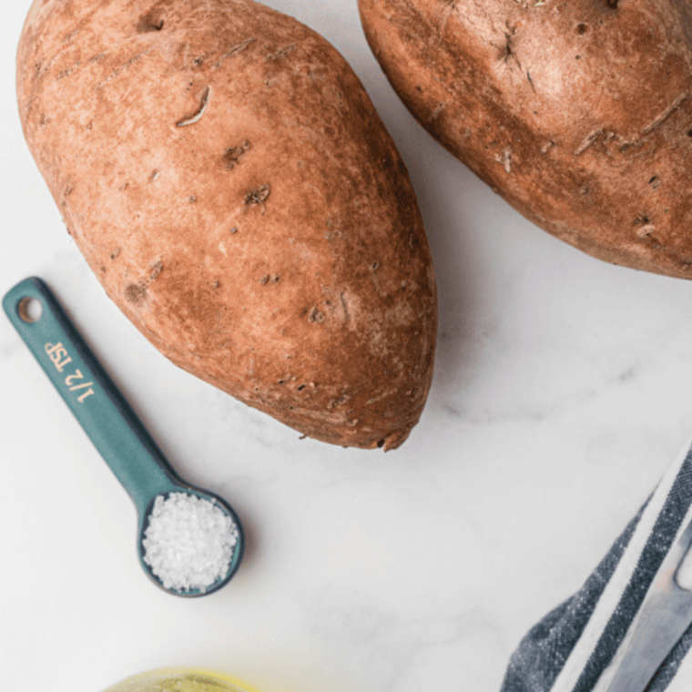 Ingredients needed for Ninja Foodi Baked Sweet Potato on kitchen table.