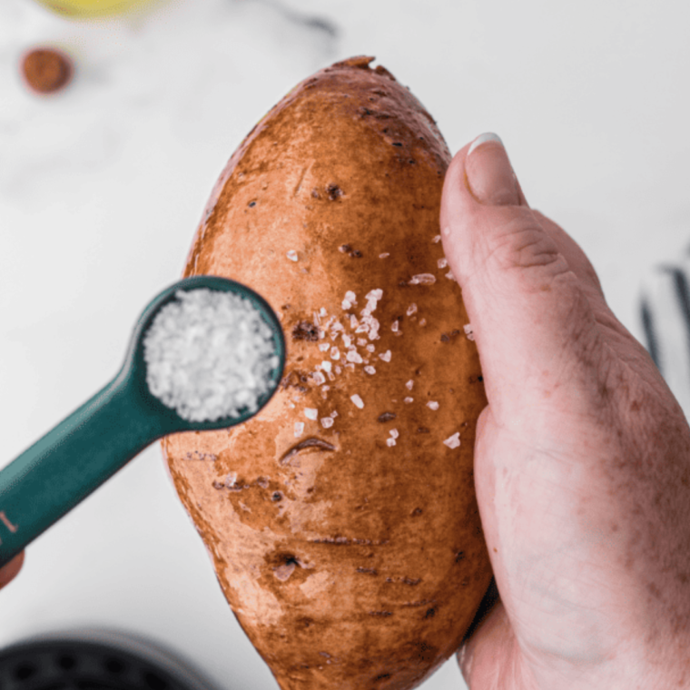 Scrubbing and drying sweet potatoes before baking in the Ninja Foodi.