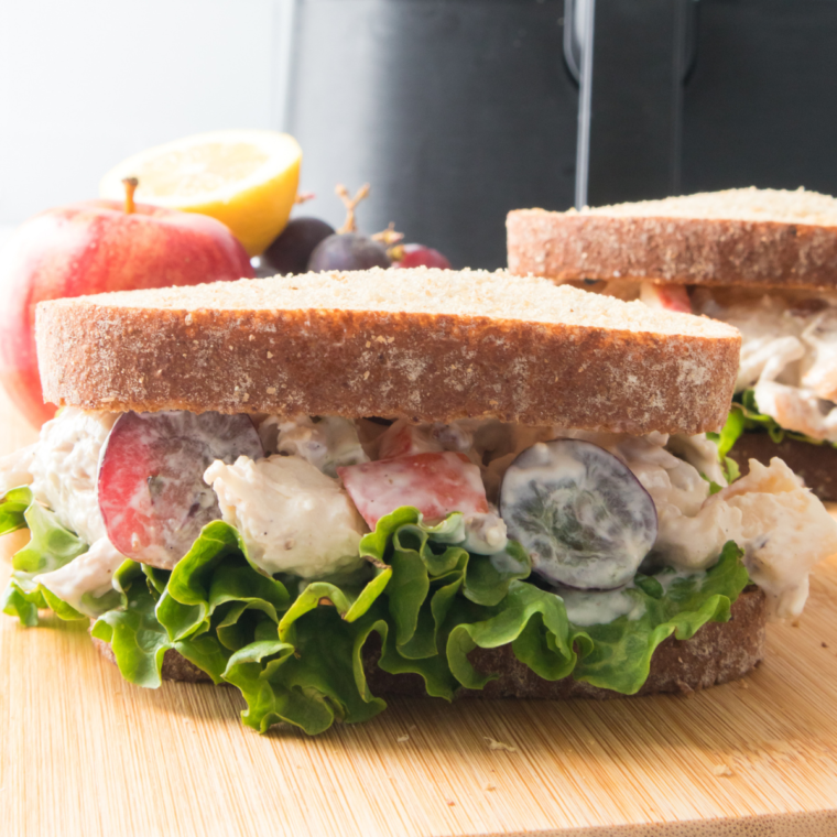 Bowl of Zoe’s Chicken Salad with fresh vegetables and creamy dressing."