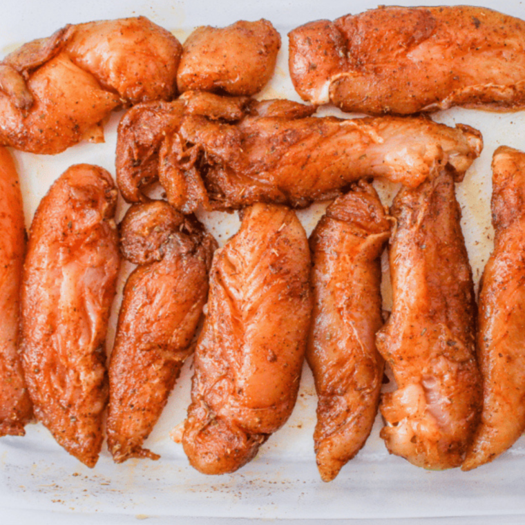 Chicken tenders coated with blackened seasoning, ready for the air fryer.