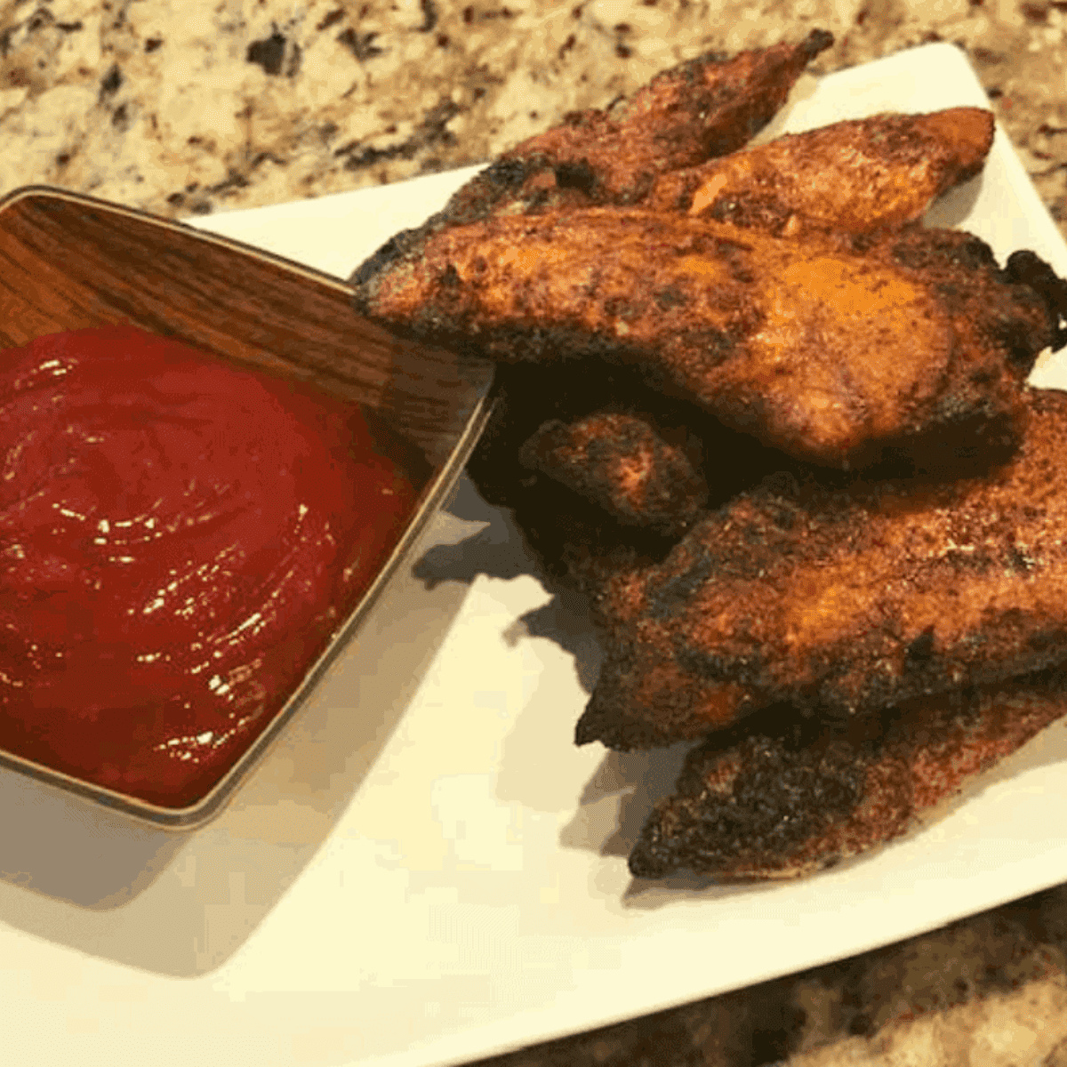 *Finished blackened chicken tenders served on a plate with a dipping sauce