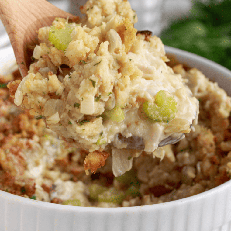 Delicious air fryer chicken and stuffing casserole served in a dish, garnished with fresh herbs.