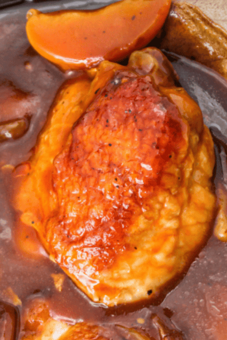 Air fryer chicken thighs with caramelized peach glaze on a serving plate
