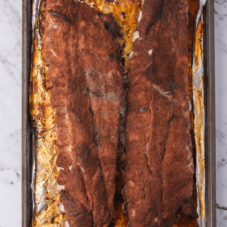 Grilled ribs seasoned with homemade fiesta rub, sliced on a board