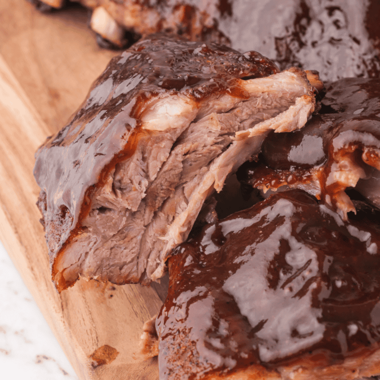 Cooked ribs seasoned with homemade fiesta rub, sliced on a wooden board