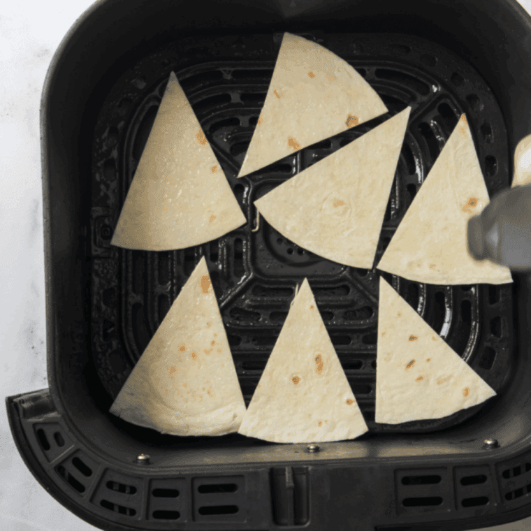 Spray Tortilla Chips with cooking oil and season.