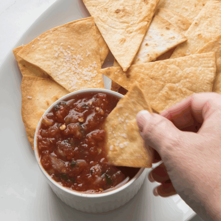 Crispy homemade tortilla chips styled like Chili’s, served with salsa in a bowl.
