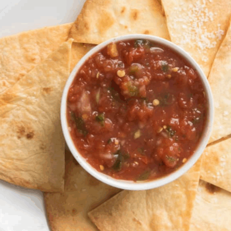 Golden crispy homemade tortilla chips seasoned like Chili’s, served with salsa dip.