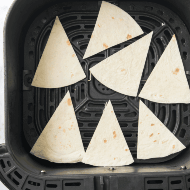 Place the tortilla wedges into the air fryer basket.