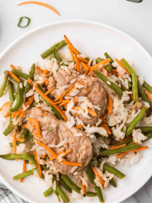 Crispy General Tso's pork with green beans over white rice in a bowl