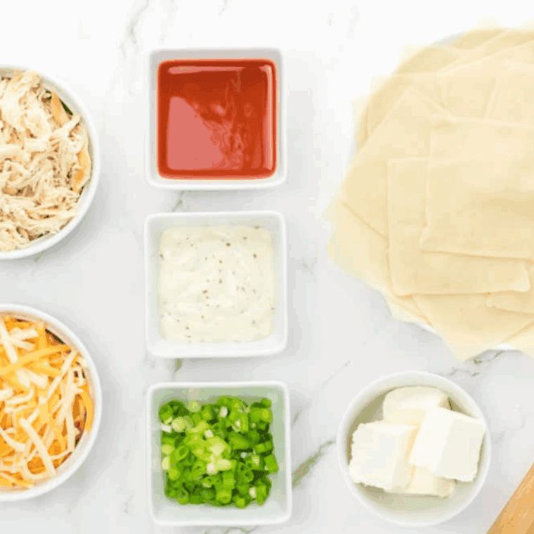 Ingredients needed for Buffalo Chicken Rangoons on kitchen table.