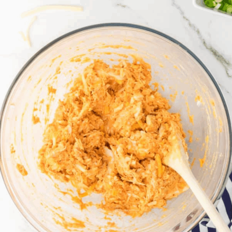 Mix buffalo chicken into a bowl.