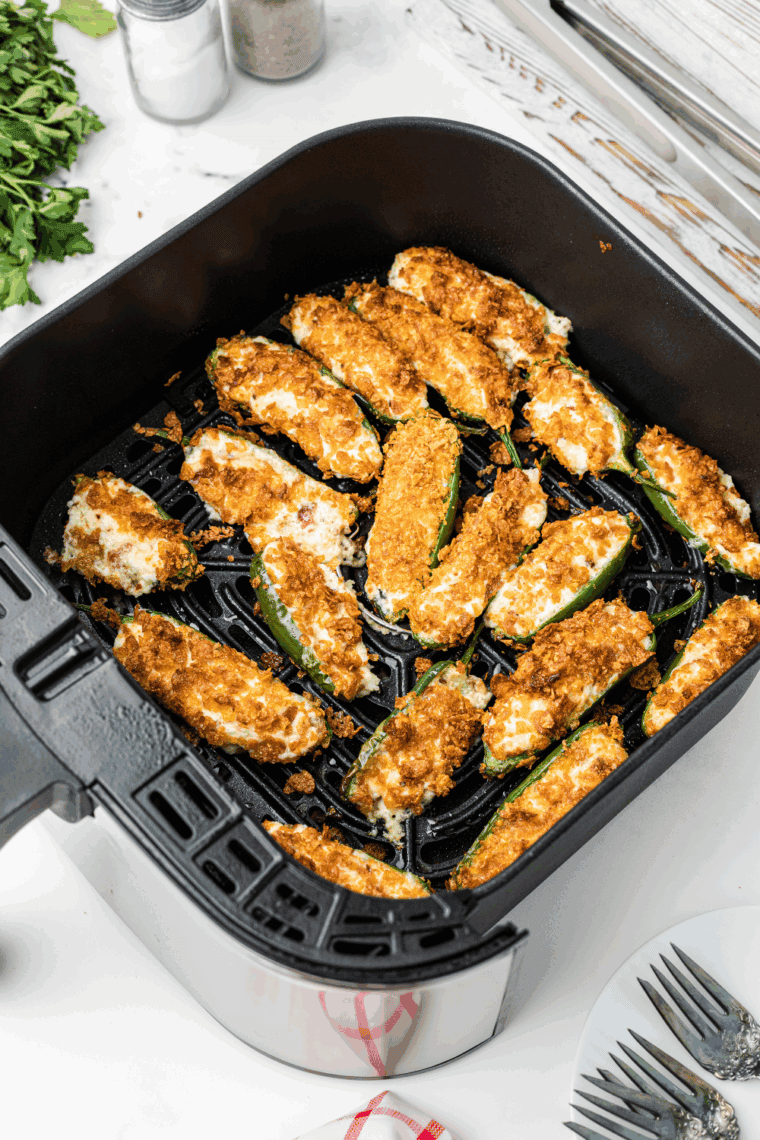 Place the jalapeno poppers into the air fryer basket.