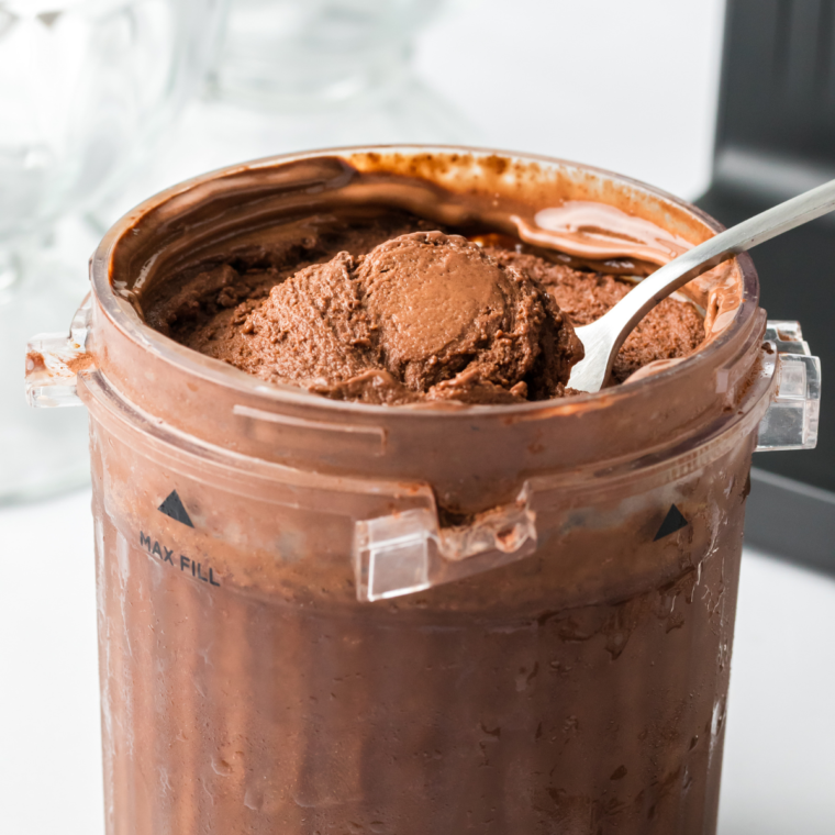 Add chocolate ice cream and milk into an empty Ninja Creami Pint Container, ready to blend into a creamy treat.