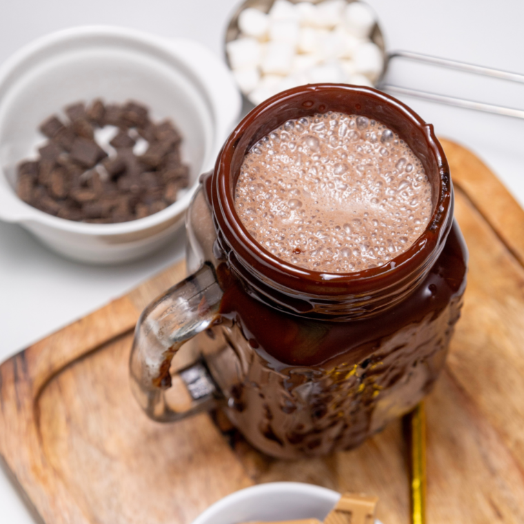 Grate blonde or salted caramel chocolate onto the glass edges, then sprinkle with marshmallows and chocolate chips for added texture and flavor.