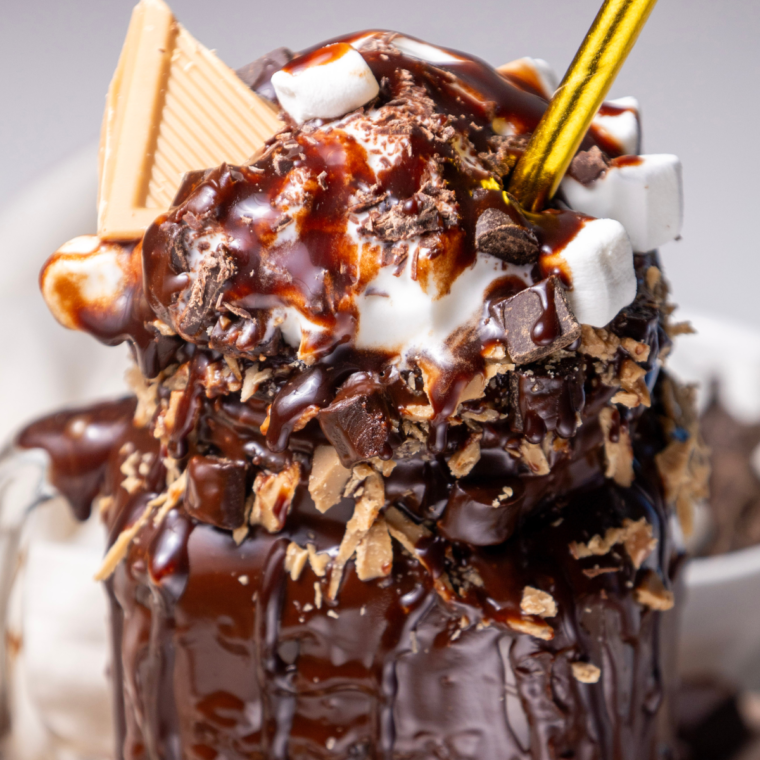 Decorate your Ninja Creami Freakshake with grated blonde or salted caramel chocolate, marshmallows, and chocolate chips for a delightful and creative dessert experience.