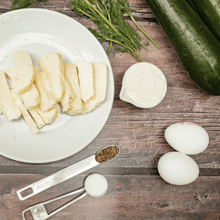 Ingredients Needed For Ninja Foodi Woodfire Zucchini Fritters on wooden cutting board.