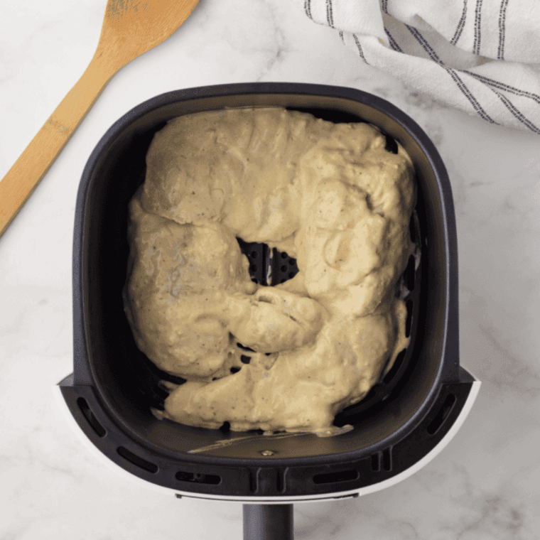 Chicken removed from marinade and placed in the air fryer basket, cooking evenly to 165°F while flipped halfway through.