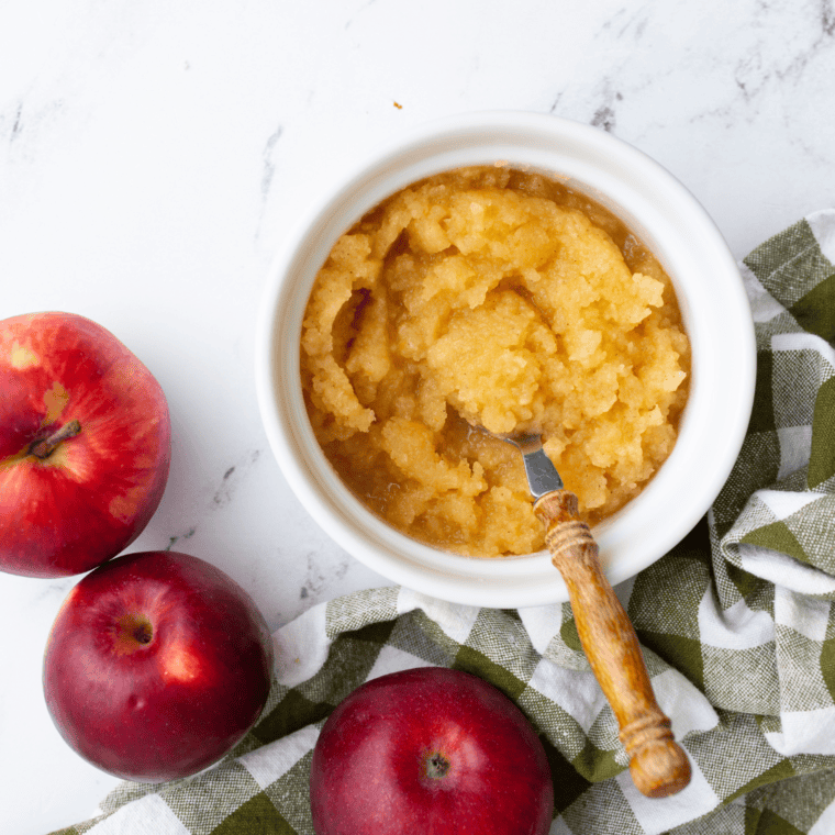 A bowl of homemade Air Fryer Applesauce garnished with cinnamon, showcasing a smooth, golden texture.