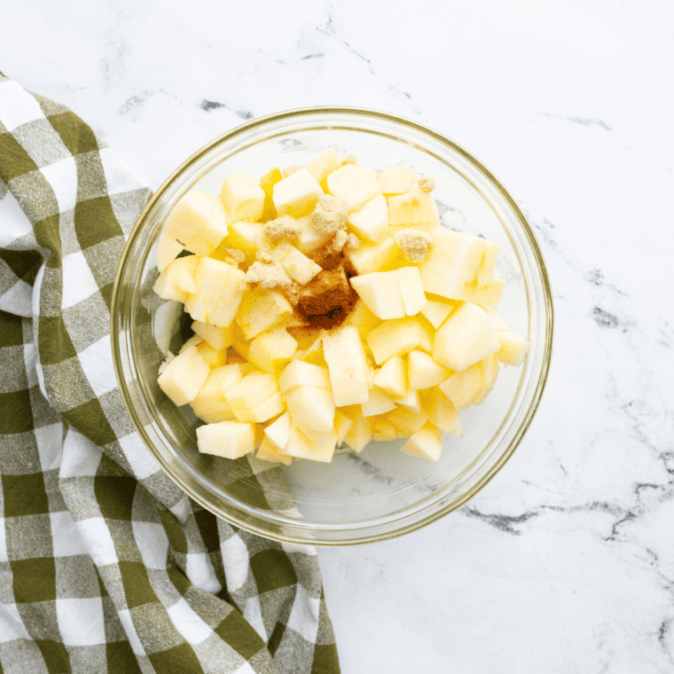 Chopped, peeled, and cored apple pieces evenly sized for air frying.