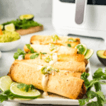 Air-fried pulled pork taquitos with a crispy golden exterior, filled with tender pulled pork for a flavorful bite.