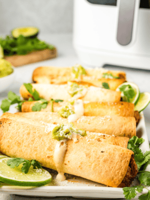 Air-fried pulled pork taquitos with a crispy golden exterior, filled with tender pulled pork for a flavorful bite.