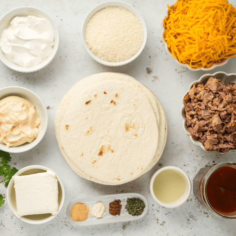 Ingredients needed for Air Fryer Pulled Pork Taquitos on kitchen table.