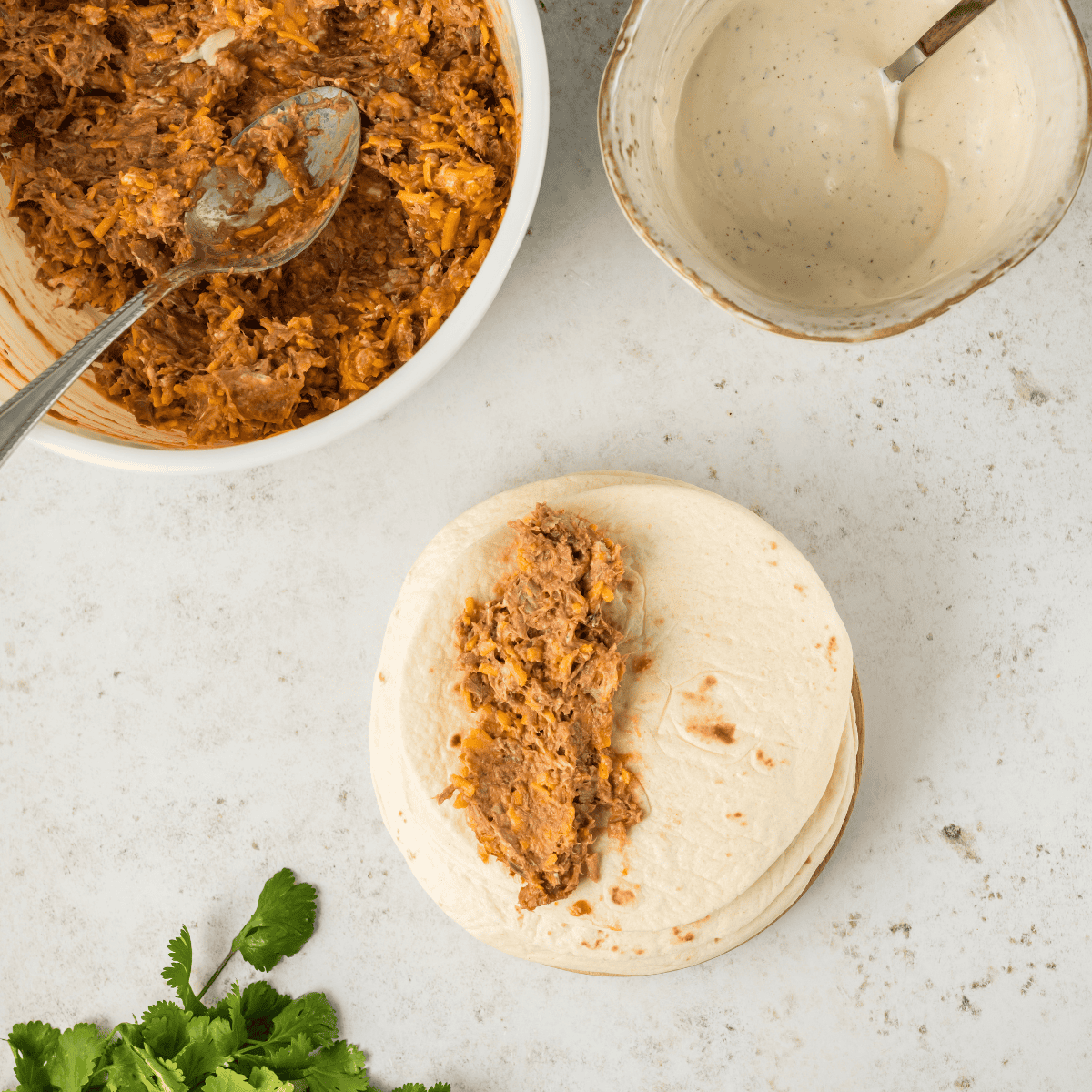 Shred the cooked pork tenderloin or shoulder using two forks after cooking until tender.