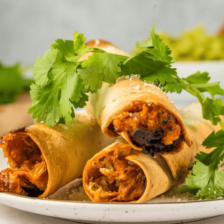 Golden, crispy Air Fryer Pulled Pork Taquitos filled with tender pulled pork and cheese.
