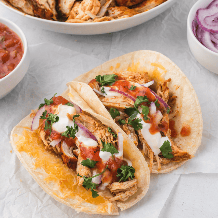 Assembled crockpot shredded chicken taco with all the toppings.