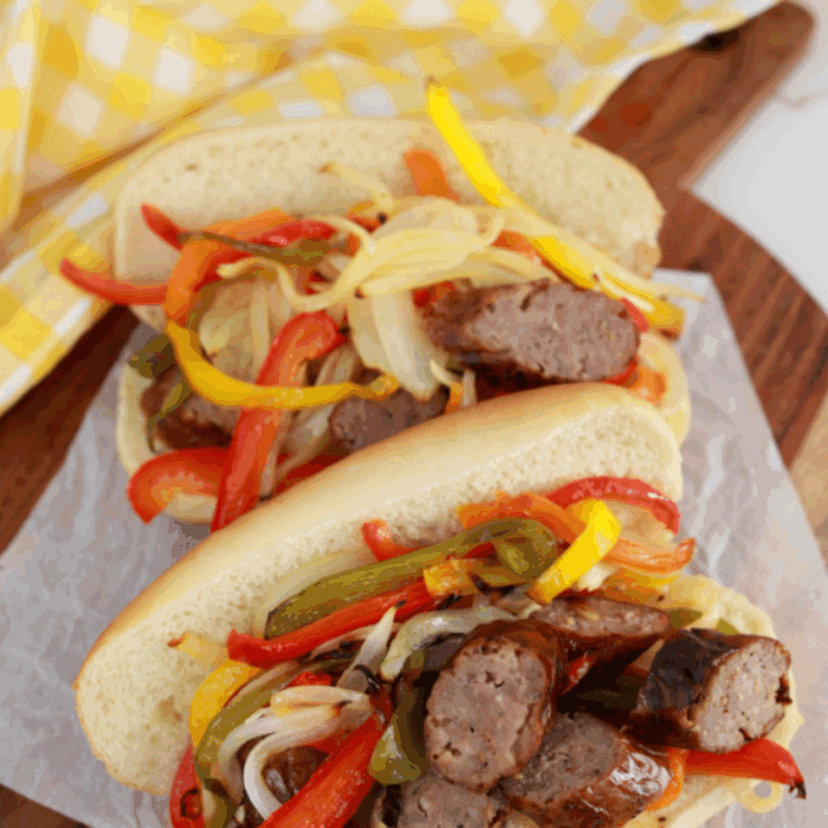 Golden Corral sausage and peppers copycat with seared sausage slices, colorful bell peppers, and onions in a skillet.