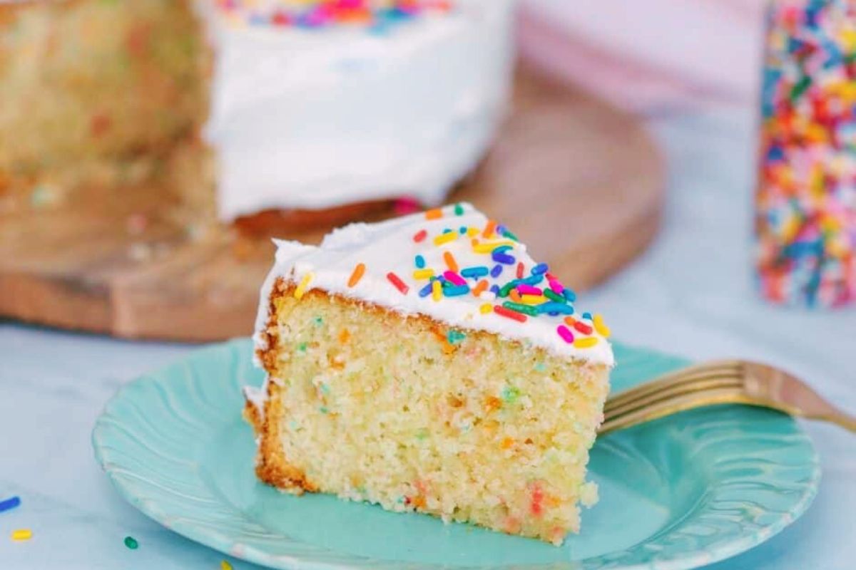 A slice of air fryer funfetti cake on a plate.
